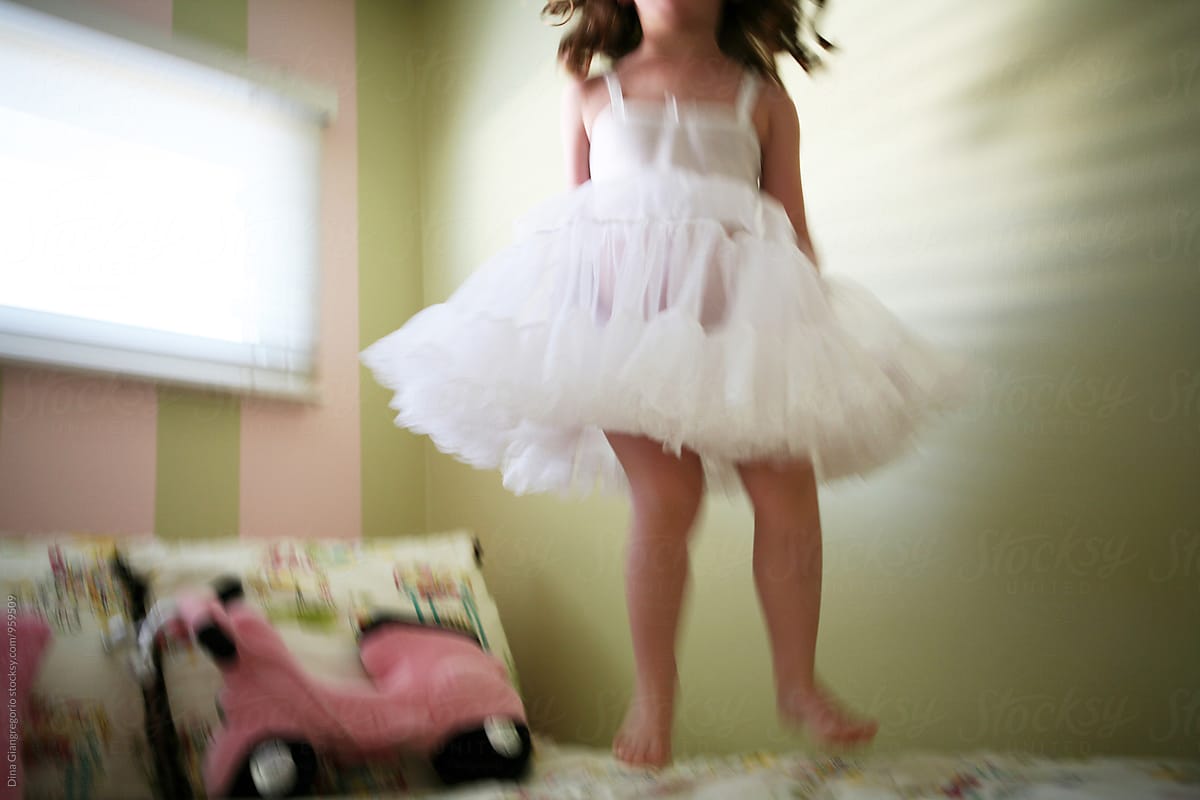 Girl In White Slip Dress Jumping On Bed Del Colaborador De Stocksy Dina Marie Giangregorio