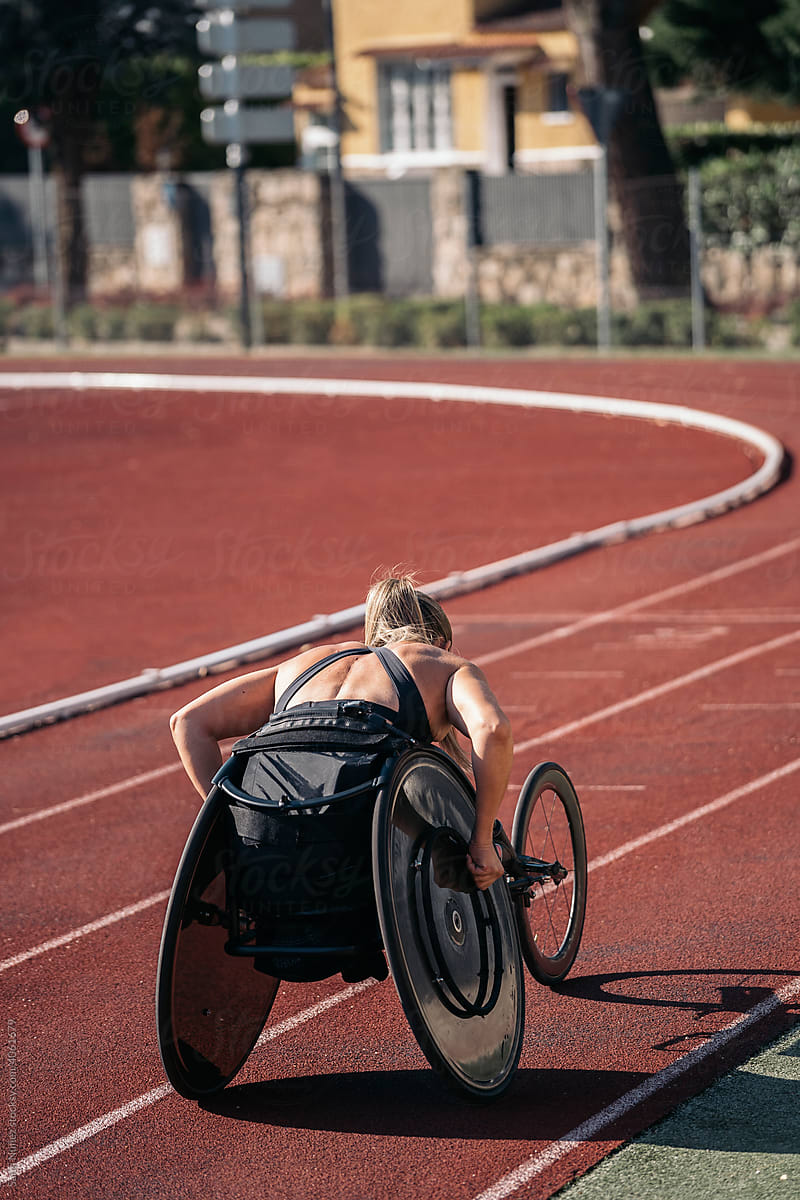 Female wheelchair athlete training on sports track