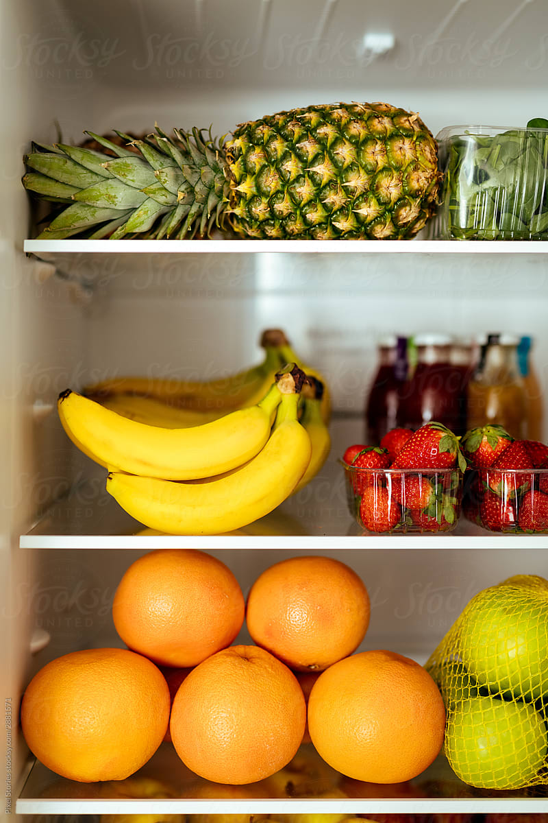 Healthy food concept: Fruits in open refrigerator