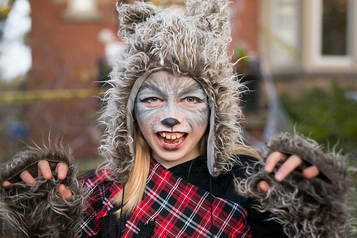 "Girl Dressed As A Bear For Halloween Makes A Growling Gesture" by