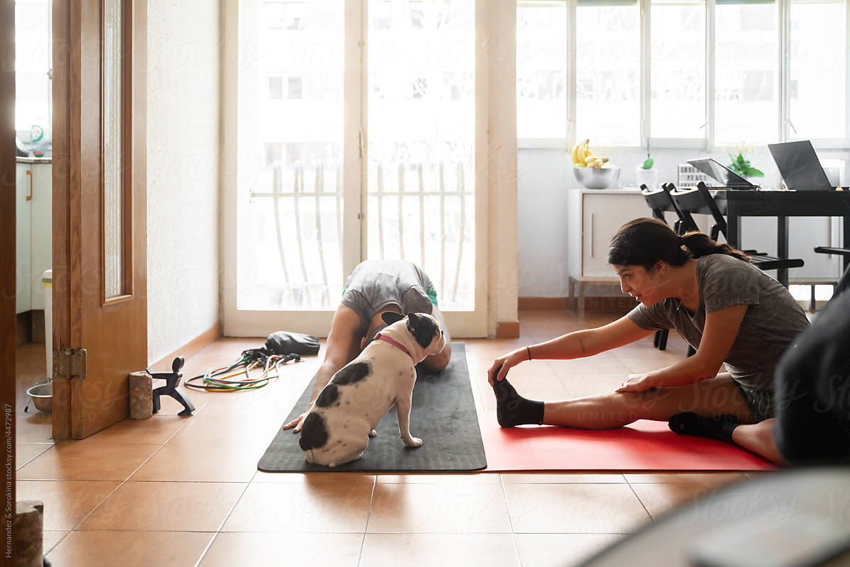 Couple Doing Yoga In Living Room