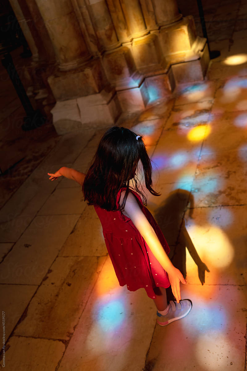 Little girl playing with colorful lights