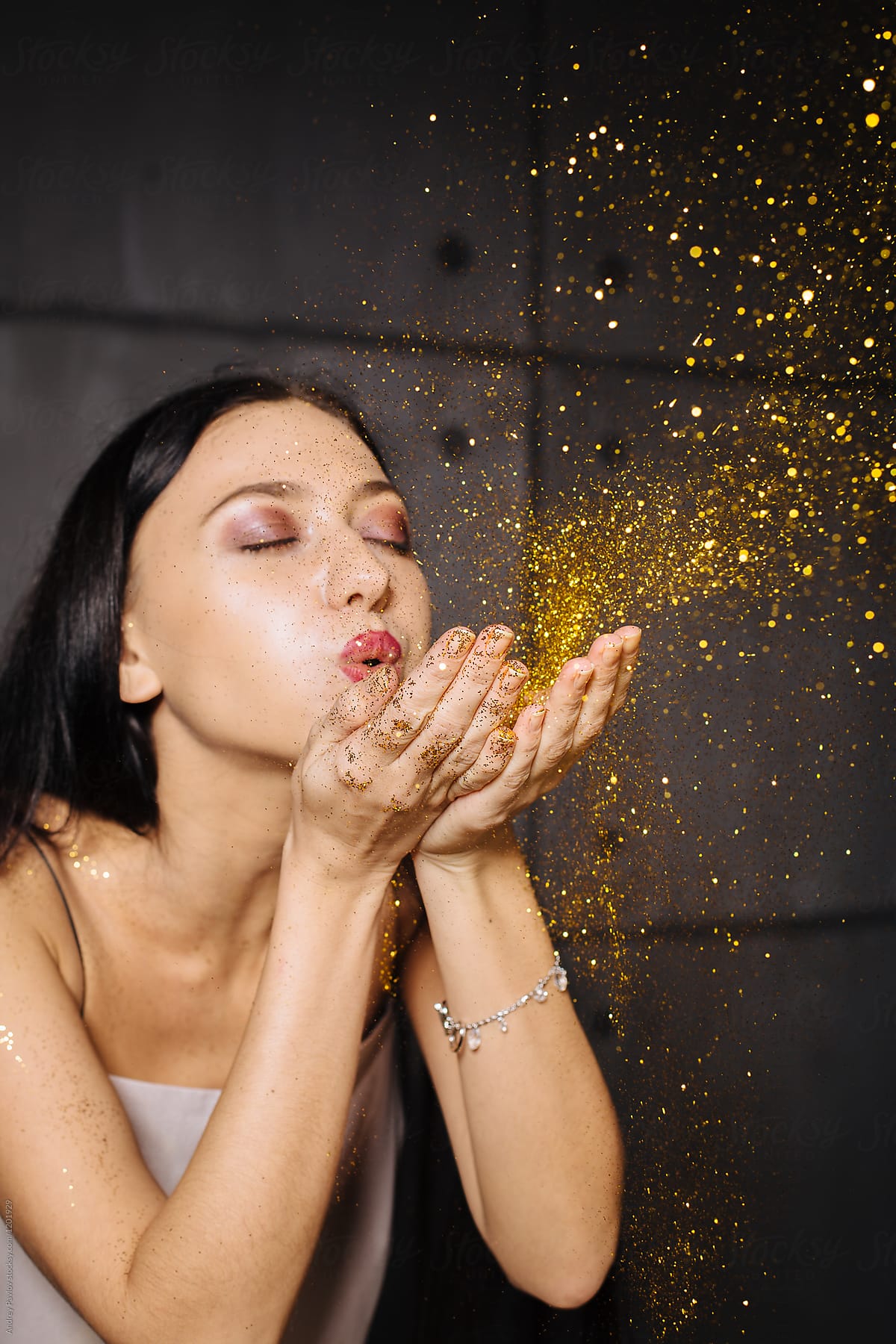 Girl Blowing Glitters Out Of Hands Del Colaborador De Stocksy Andrey 