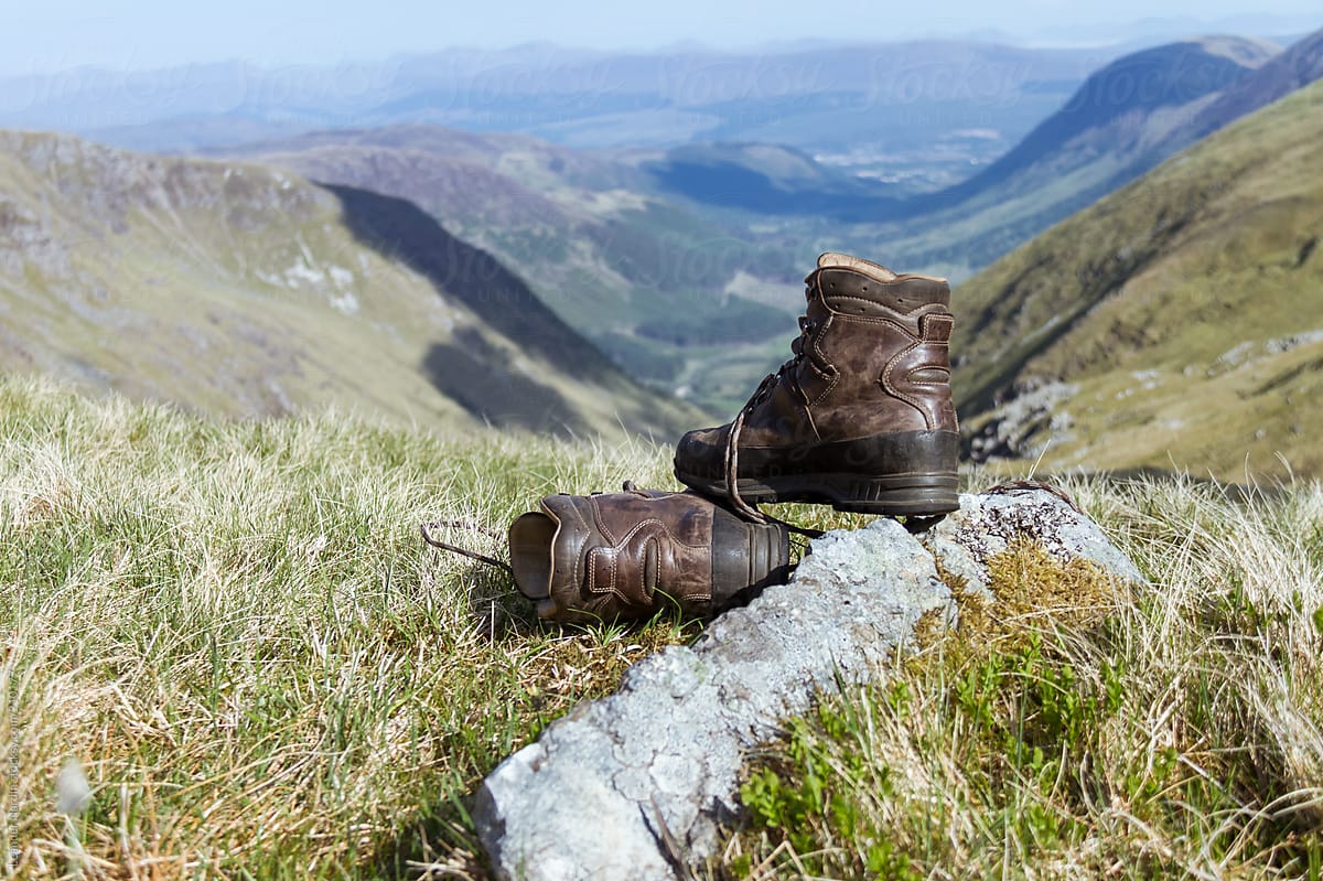 mountaineering boot with scottish highlands in the back