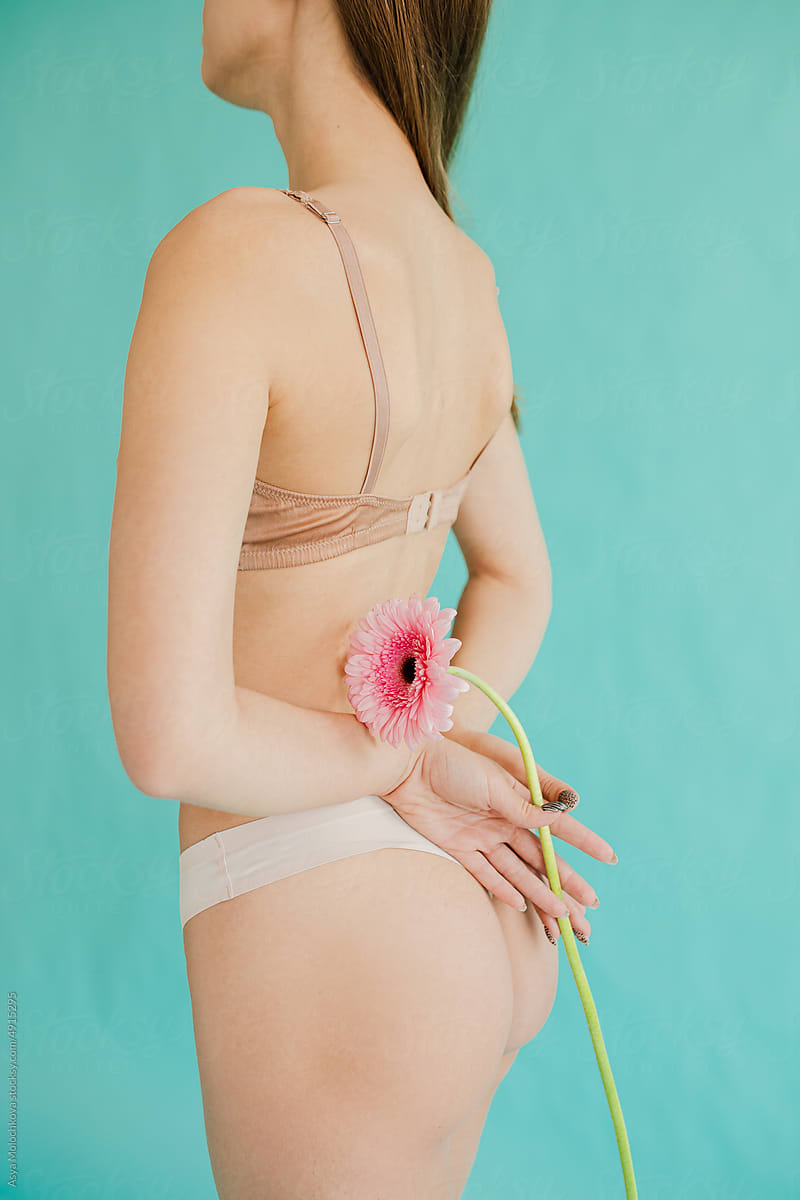 Woman with flower. Beauty body parts