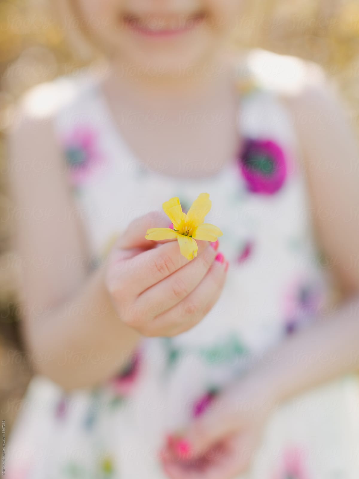 Girl holding a forsythia flower