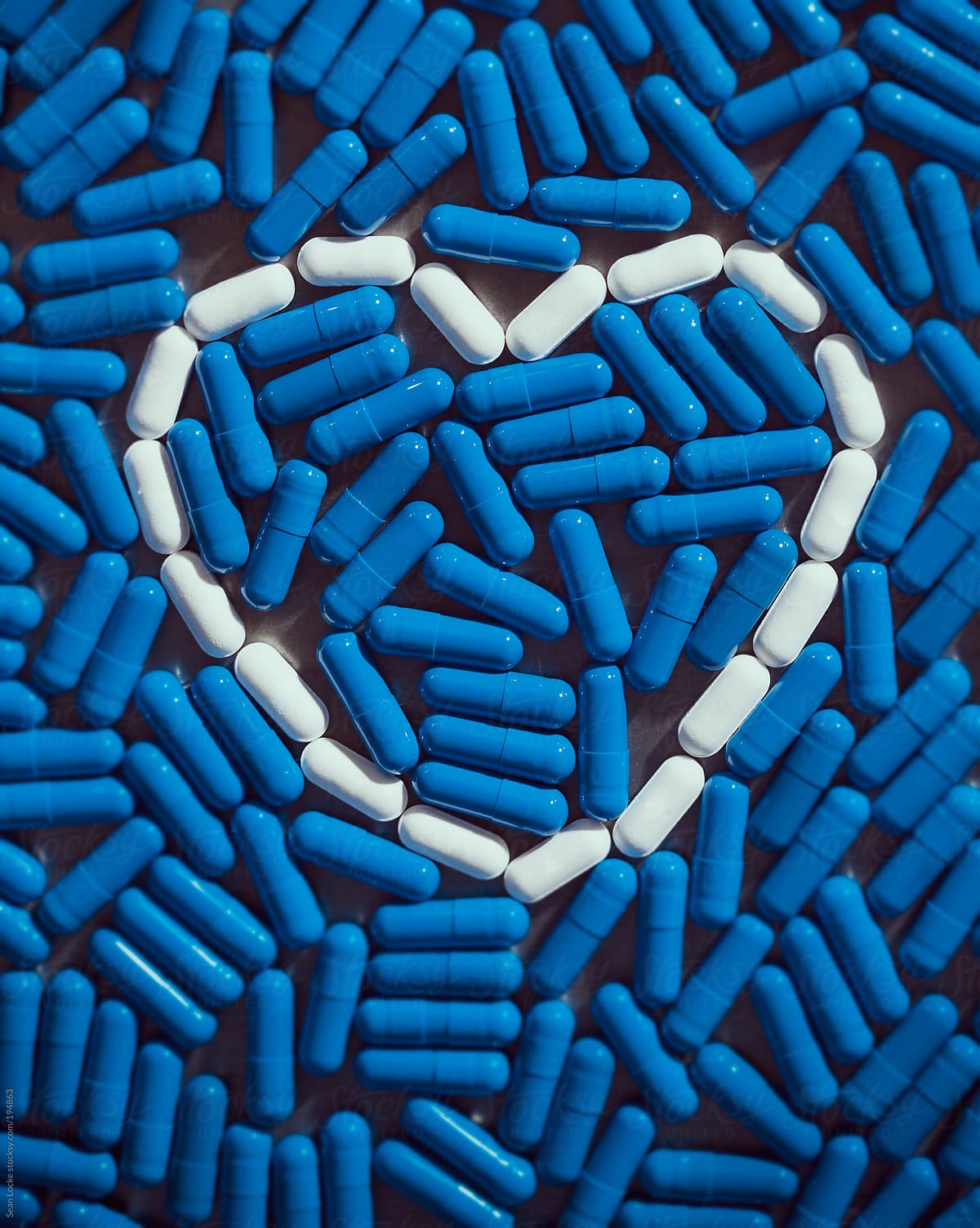 Medicine: Pills Outline Heart With Blue Capsules