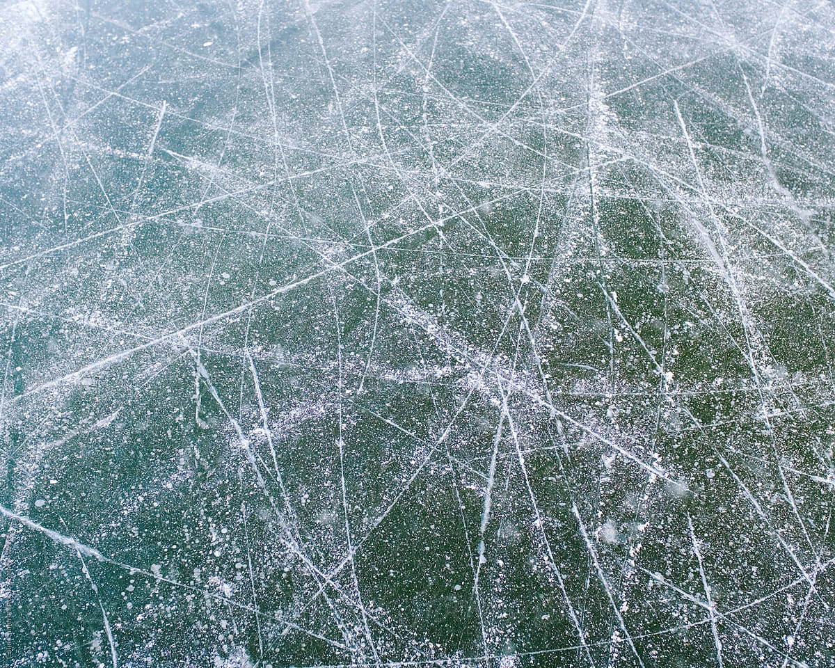 Skate tracks cut through vivid lake ice