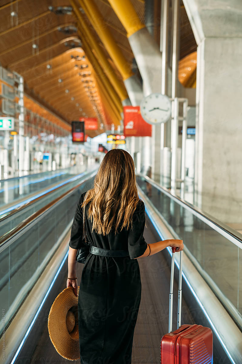 Traveler on moving walkway in airport
