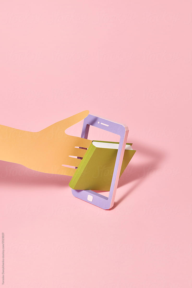 Papercraft smartphone frame with book and paper hand.