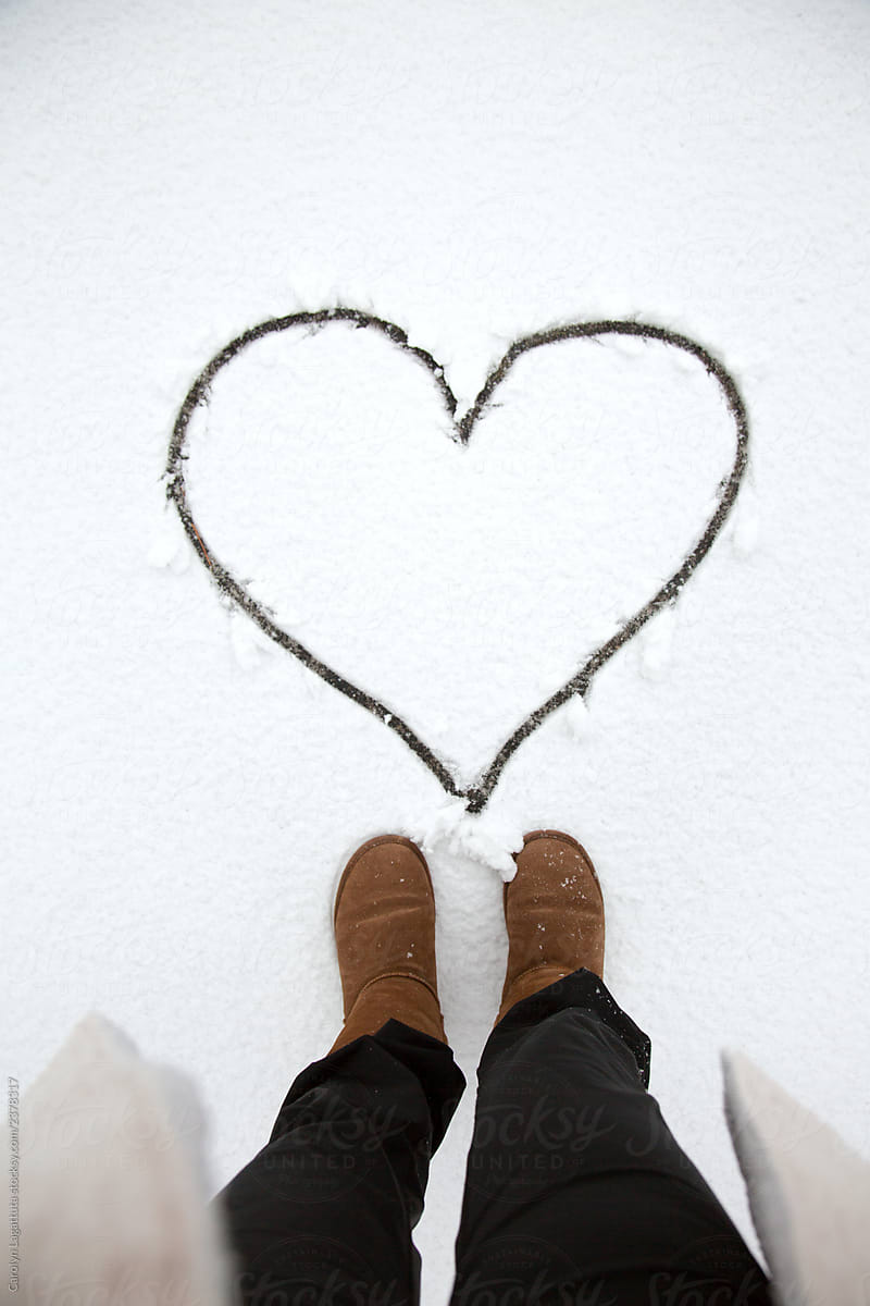 Feet above a heart carved into the snow