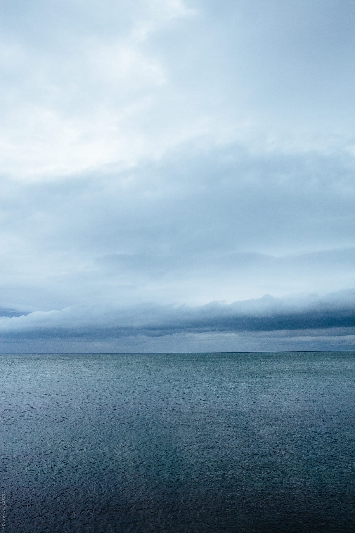 Horizon . Ocean With Cloudy Sky . Blue tones