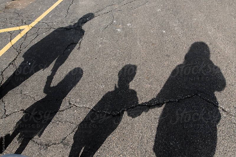 shadows of family holding hands