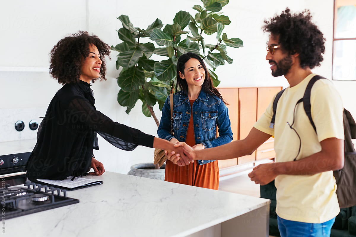 Black real estate agent shaking hands with customer