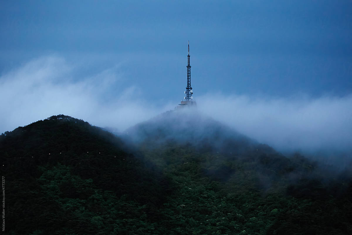 Early Morning Fog Rolling Past A Tower In Huangshan, Anhui, China.