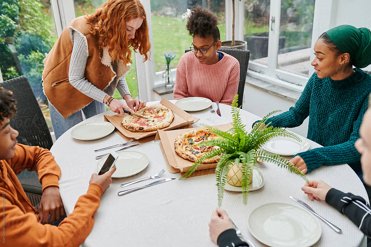 Young teens having a pizza party