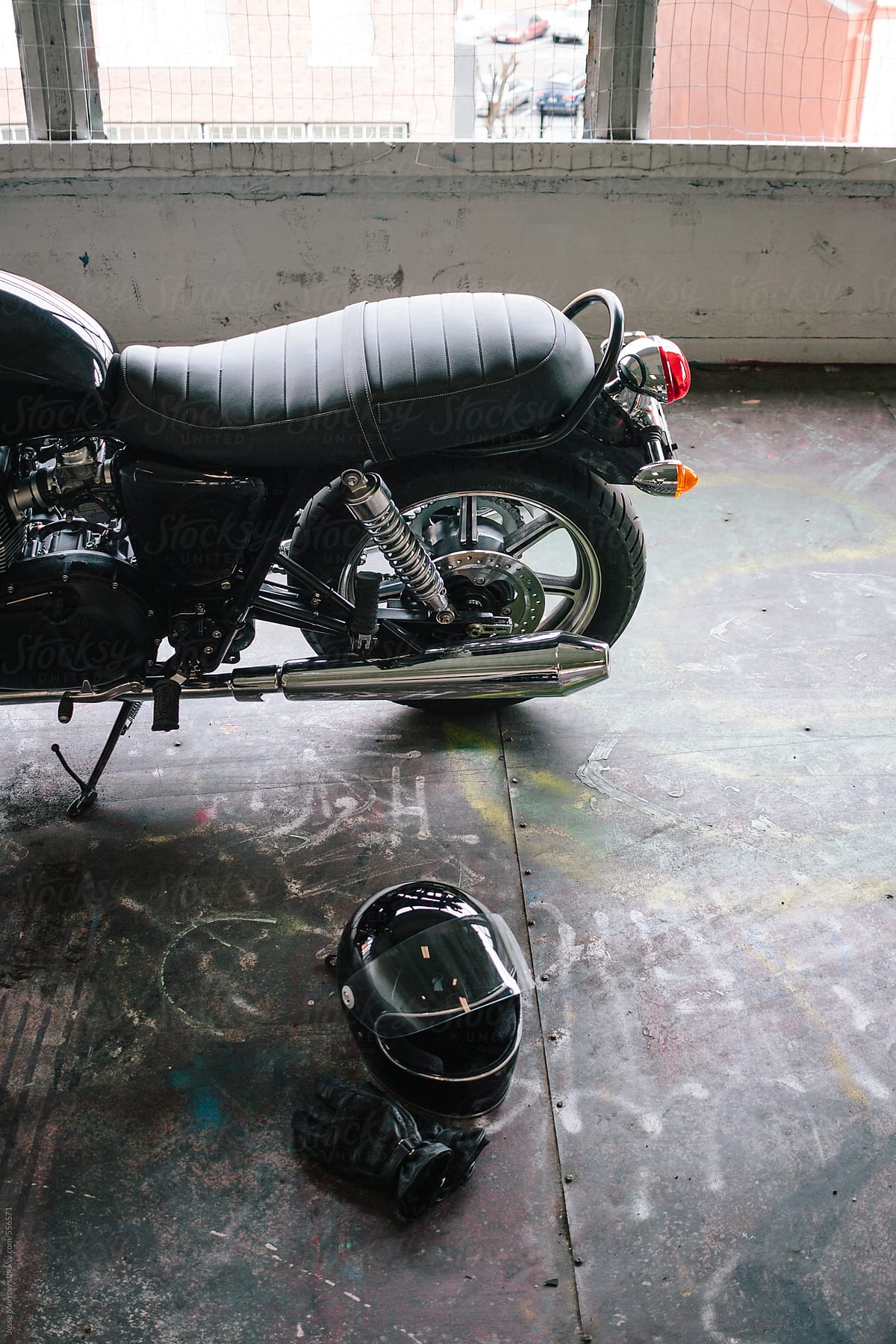 motorcycle with gloves and helmet in abandoned warehouse