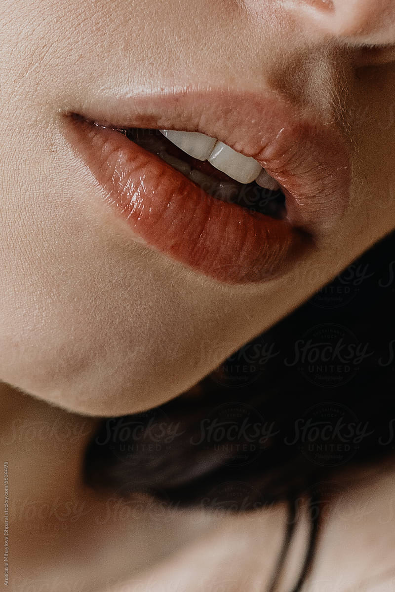 Close up of sensual big plump red lips of anonymous woman