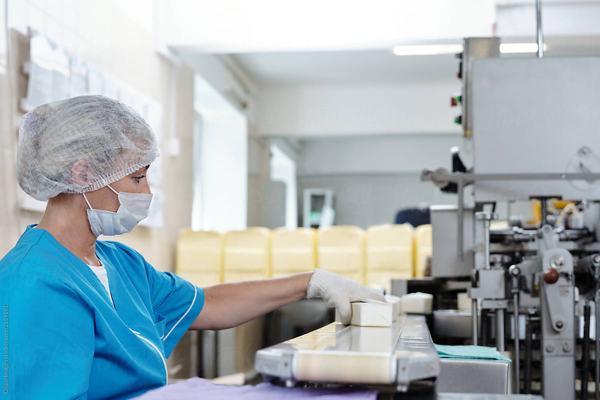 Woman Working On Butter Package Line
