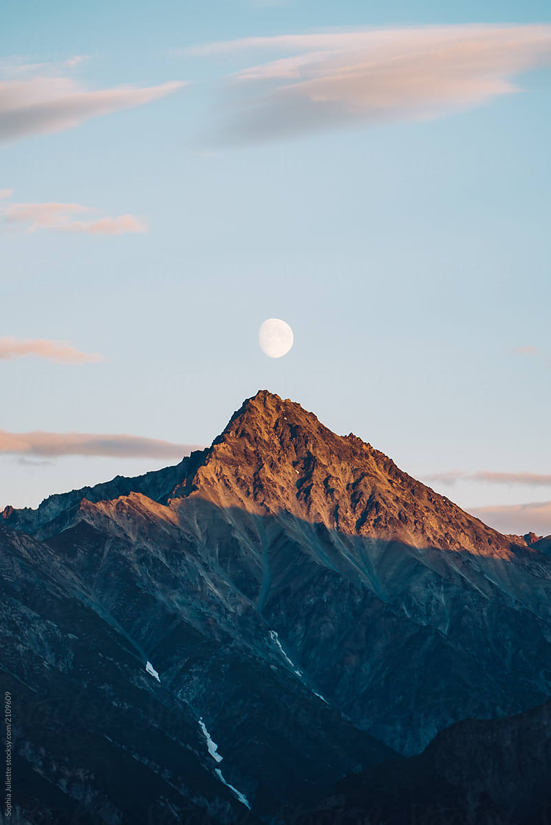 Waxing Gibbous Moon Rising Above a Sunset-lit Peak