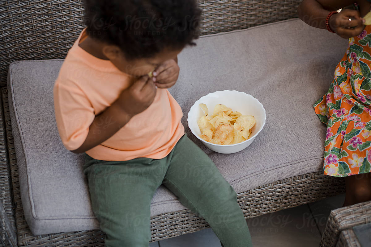 Toddlers eating chips
