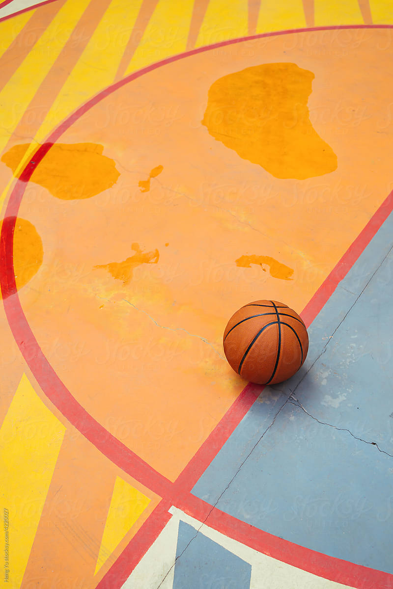 Basketball on colorful wet playground