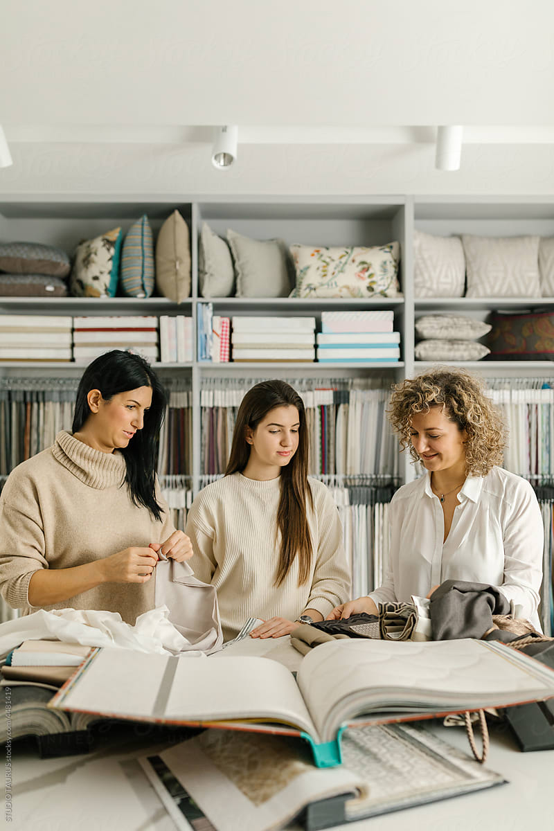 Women Looking At White Fabric In A Store