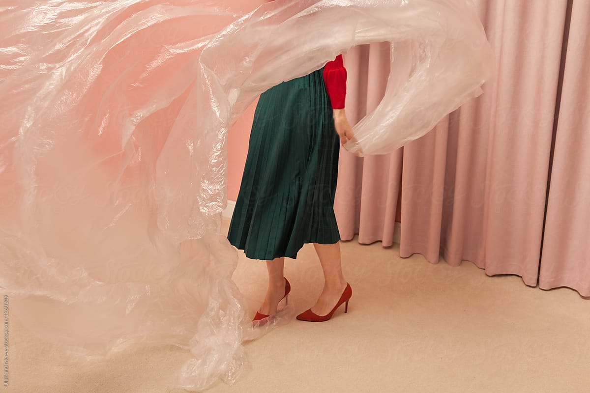 stylish woman playing with plastic sheet