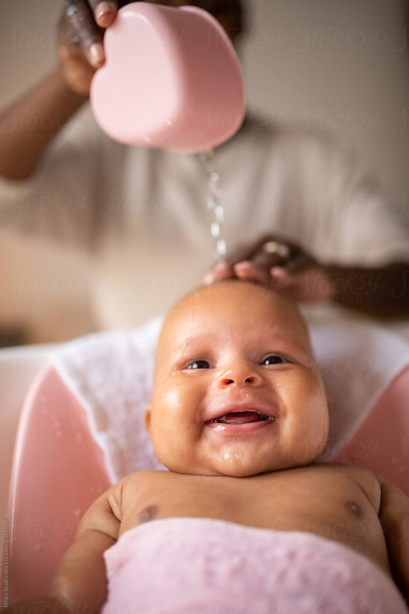 Happy baby girl having bath time