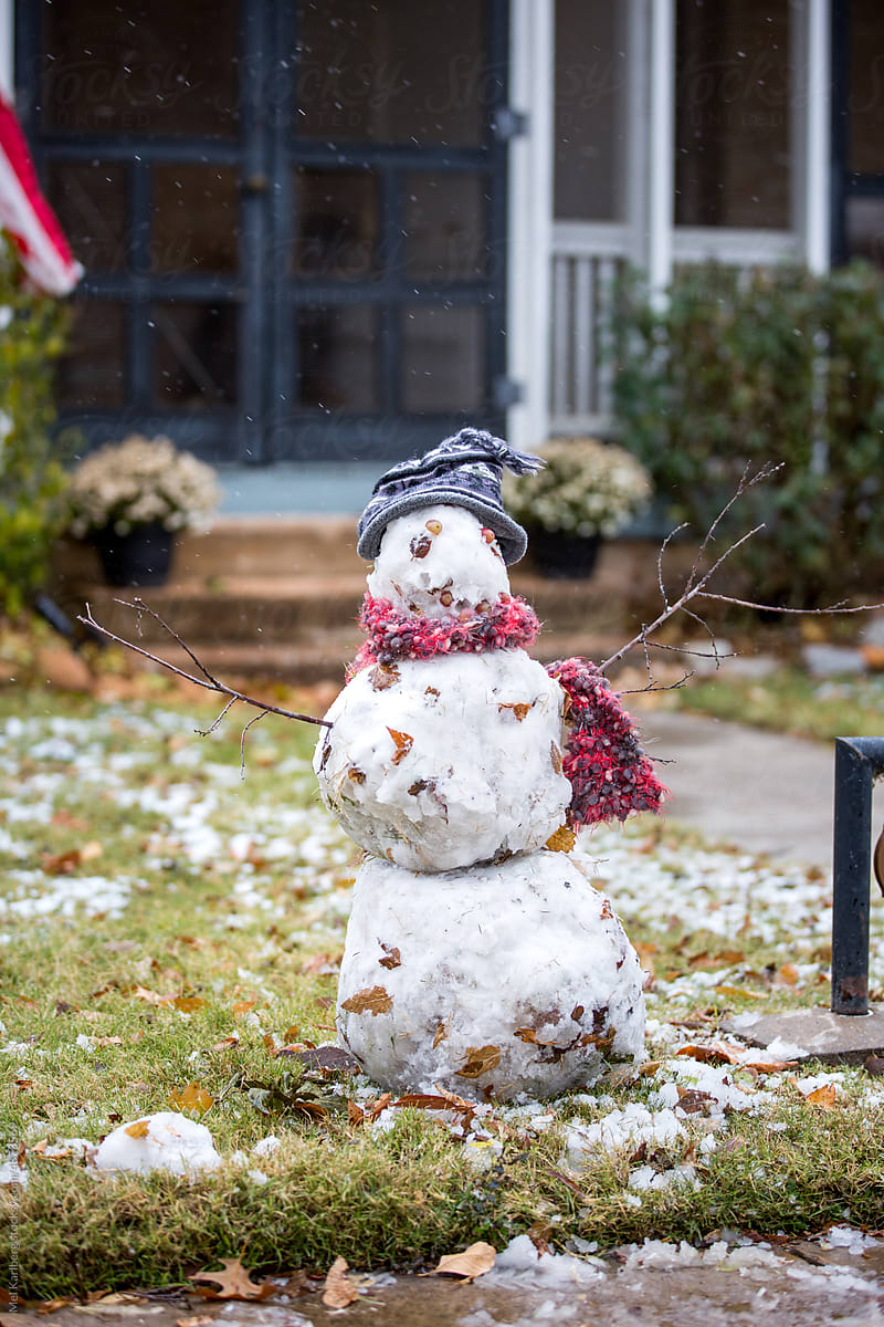 Dressed up snowman in a front yard