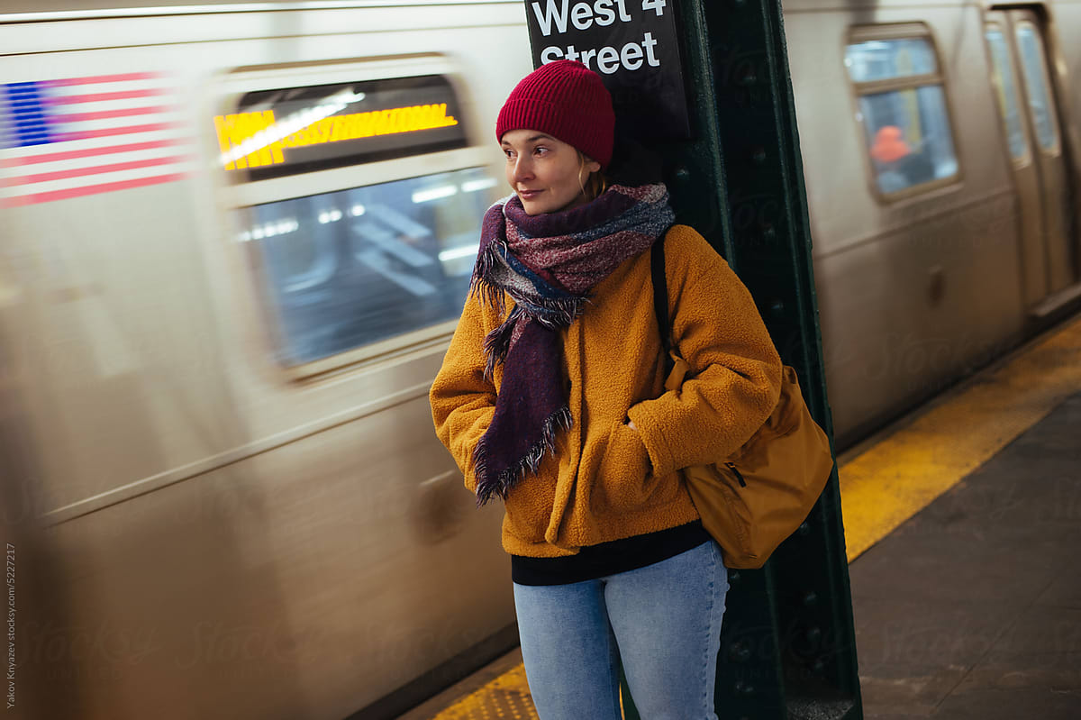stylish woman standing on the Subway station