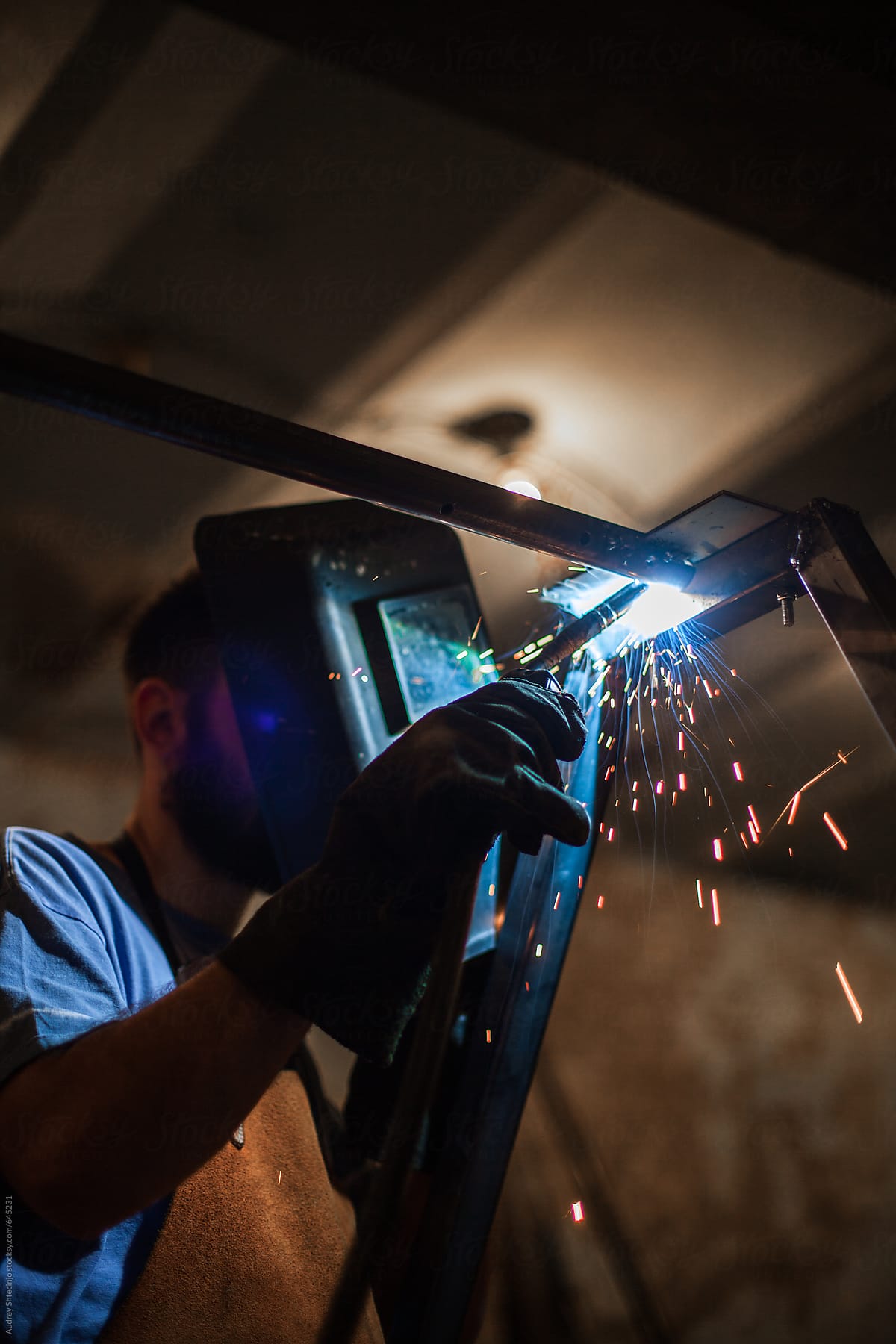Man welding in his workshop.