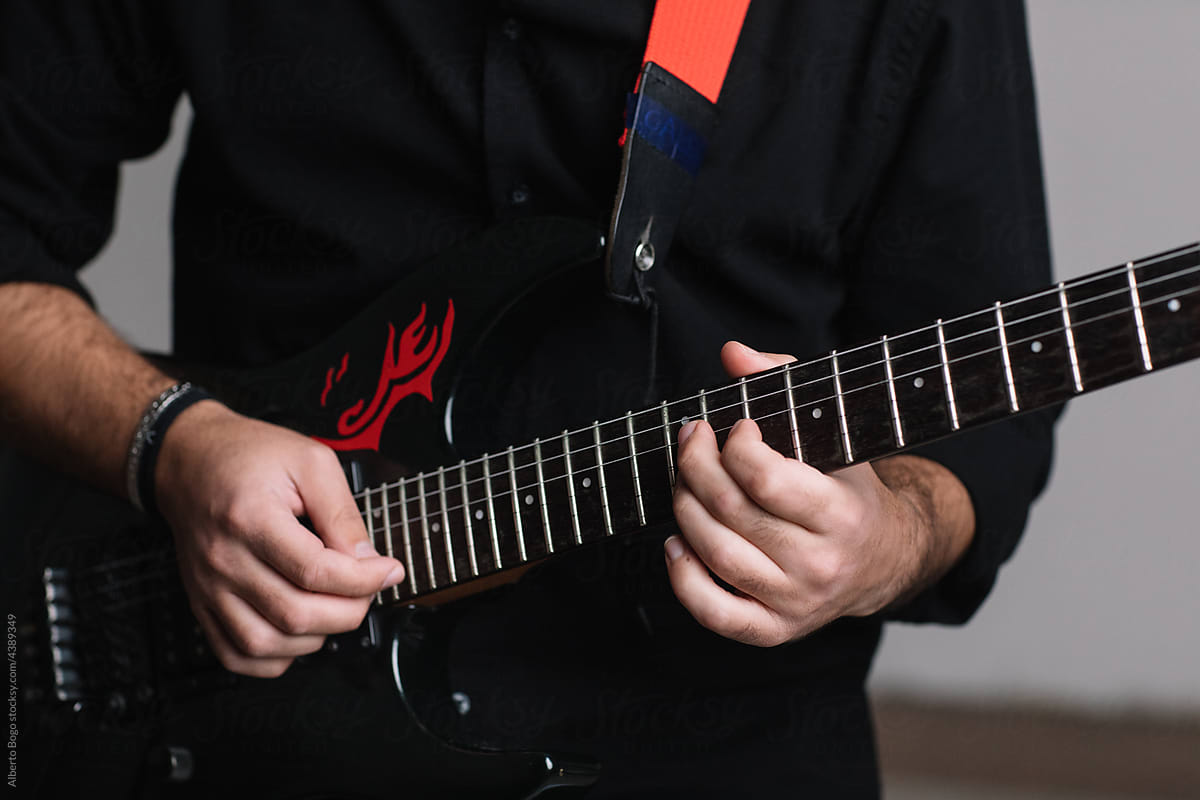 Detail Of Rock Artist Playing Electric Guitar In Studio