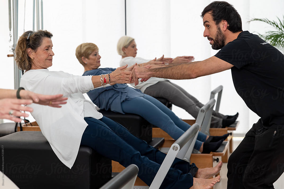 Group of people exercising with Pilates coach