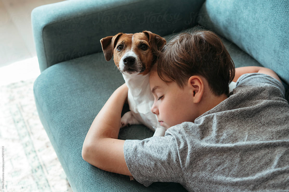 Kid resting together with pet.
