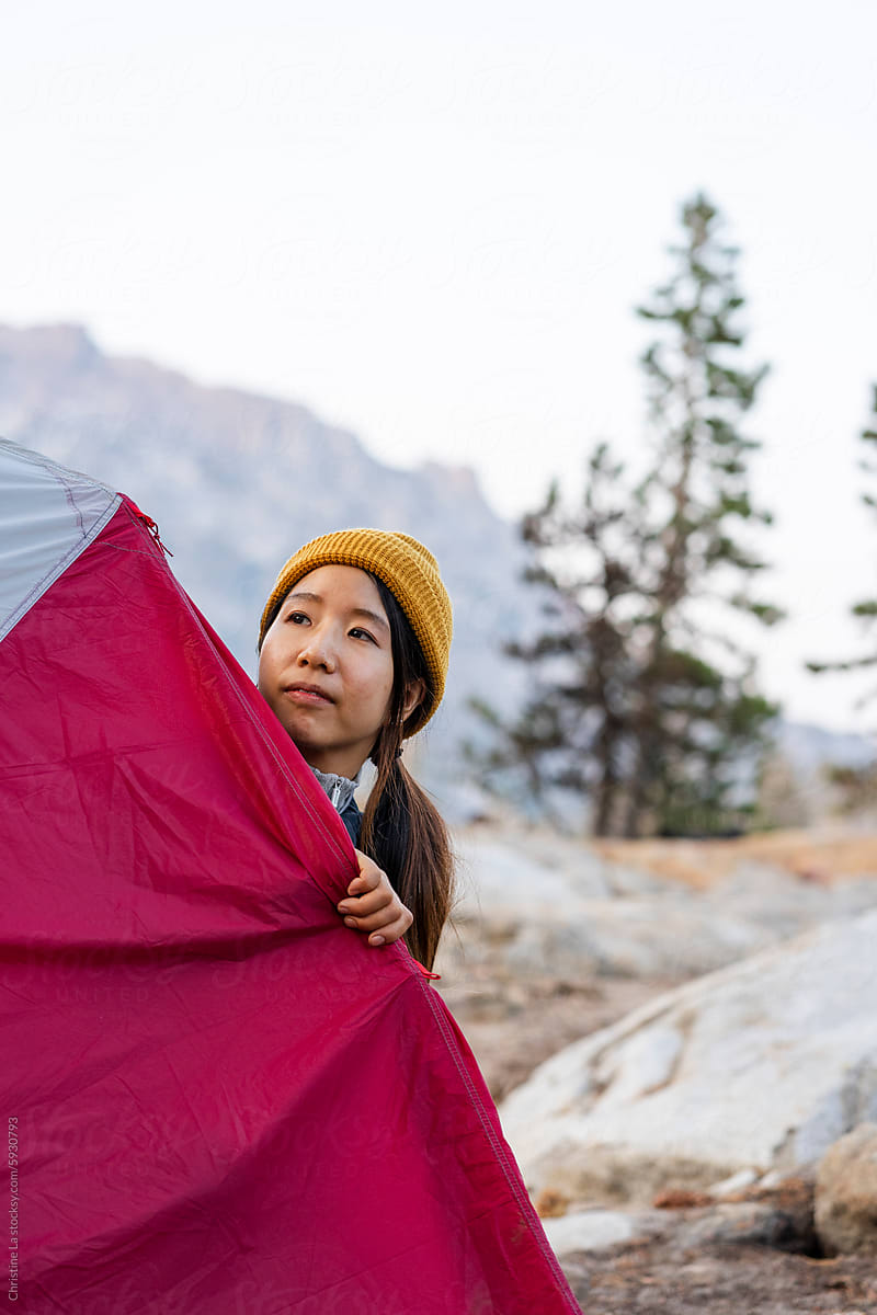 Woman looking out of tent