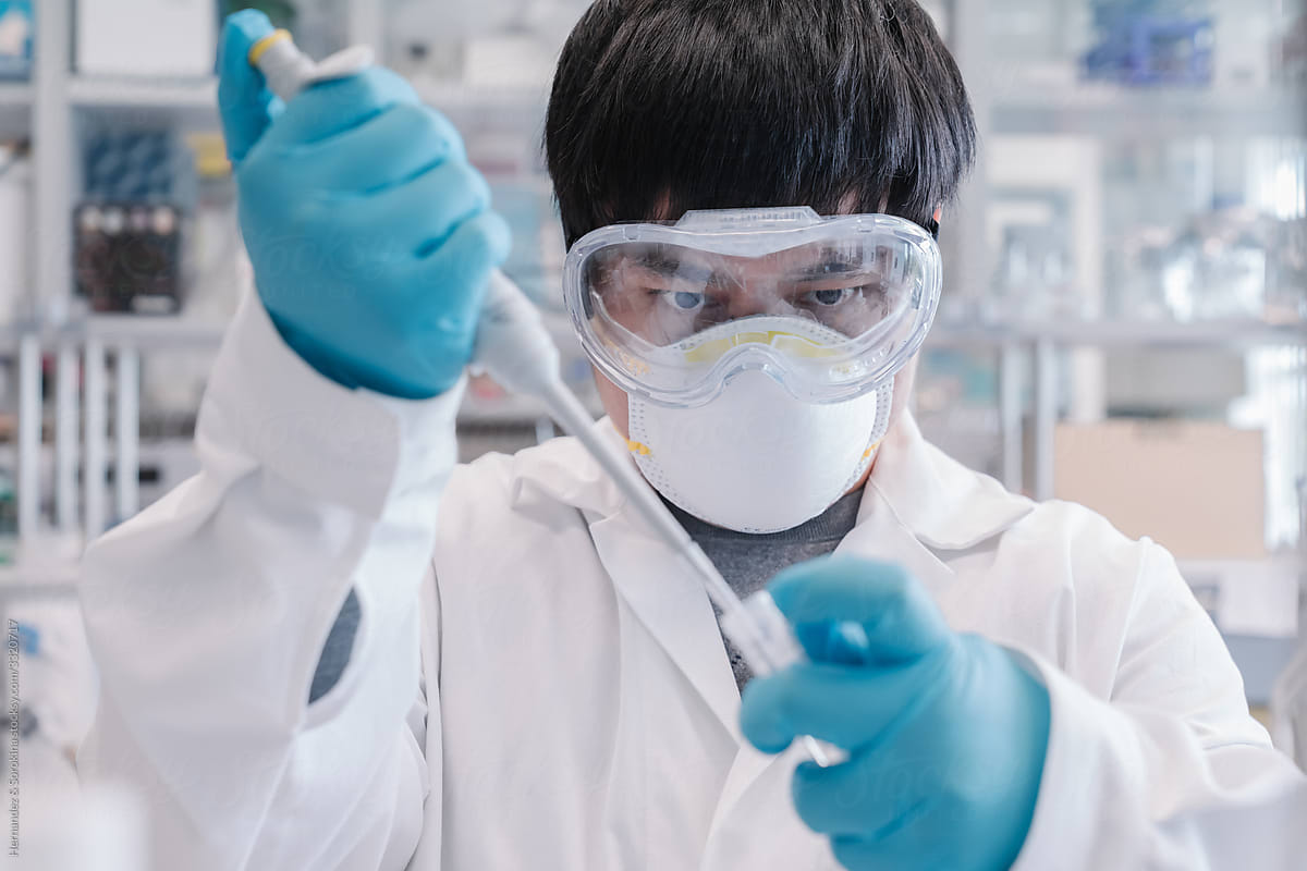 Scientist In High Protection Using Pipette