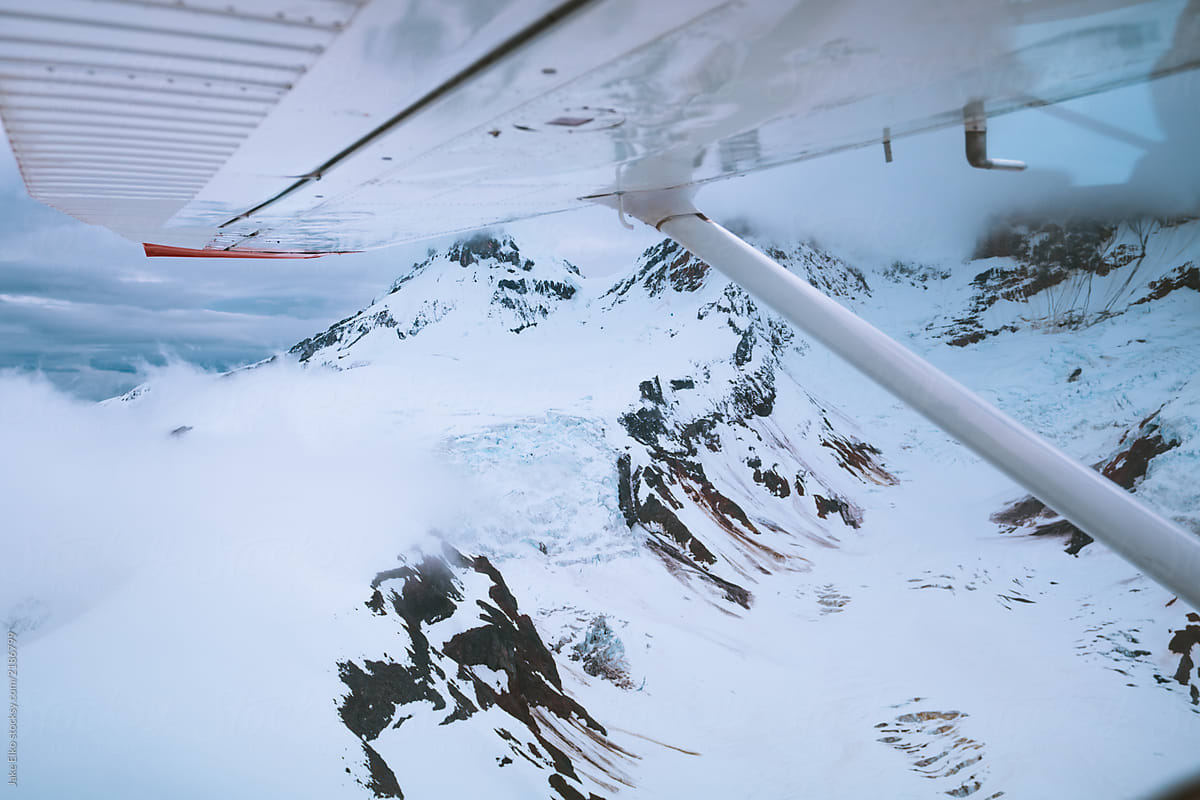 Looking Out Plane Window at Glaciers and Mountains