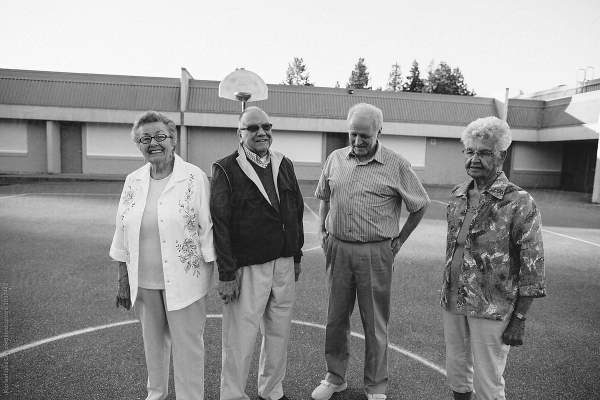 Funny portrait of grumpy caucasian seniors outside at schoolyard basketball courts