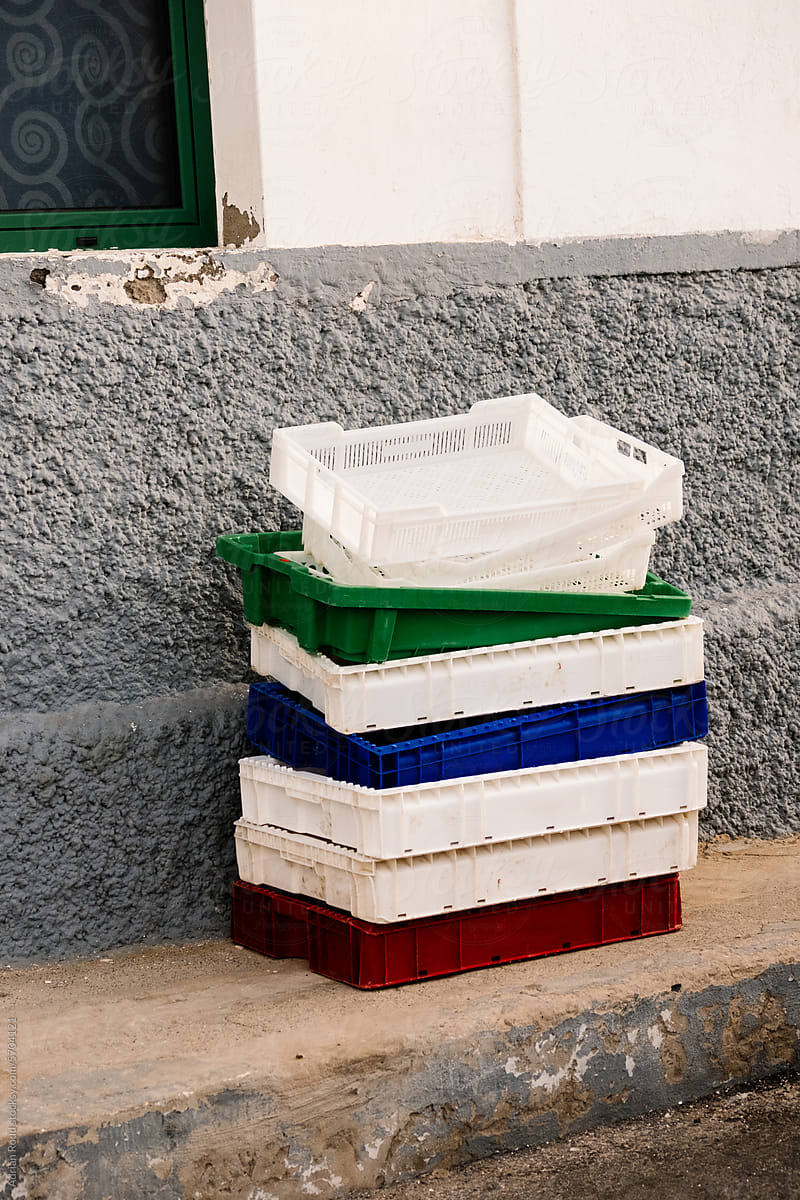 A pile of plastic trays stacked in the street