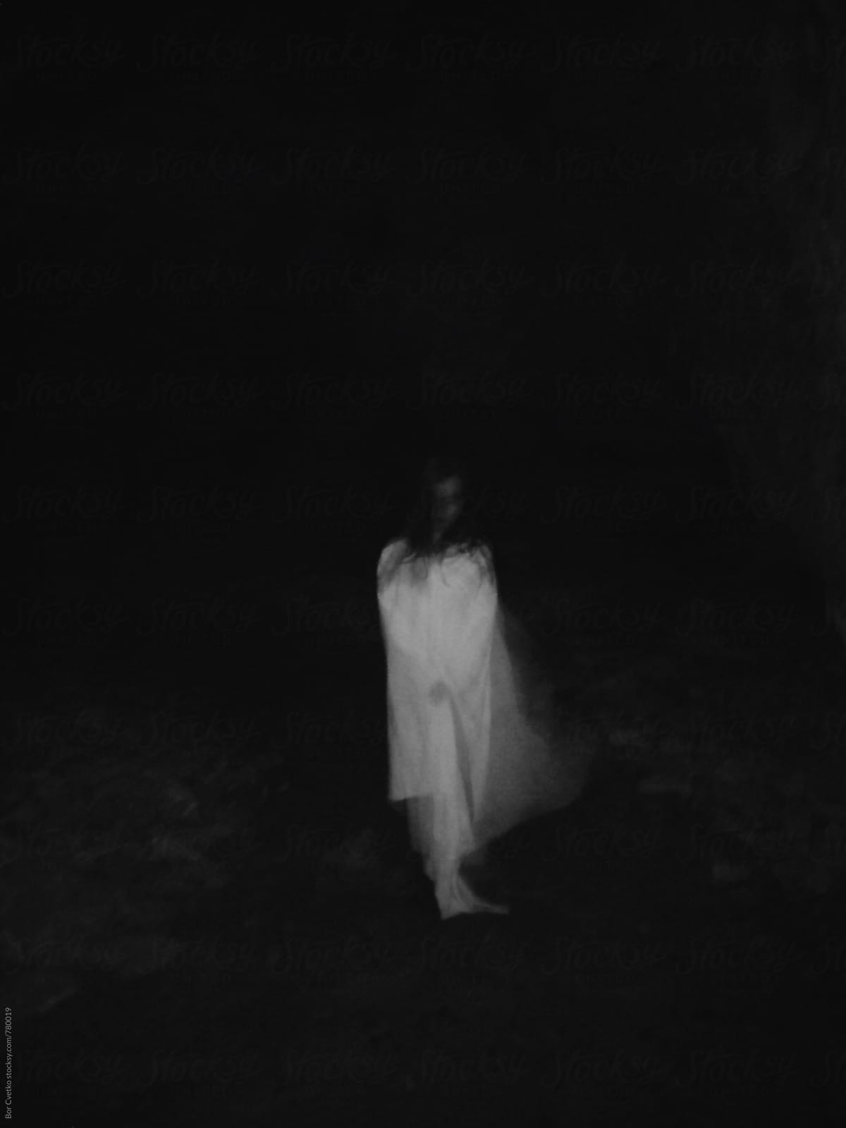 Girl in white dress in the dark