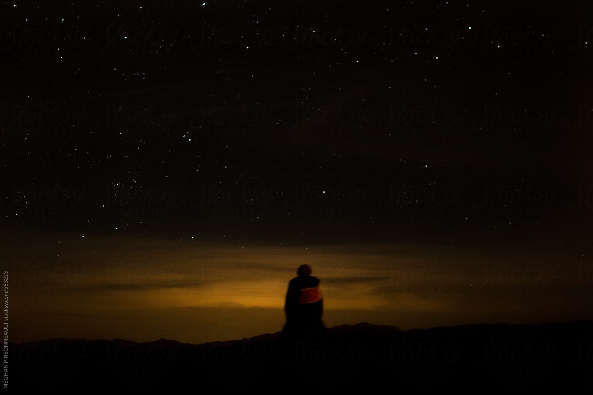 Silhouette of Woman Wearing Beanie Against Night Sky