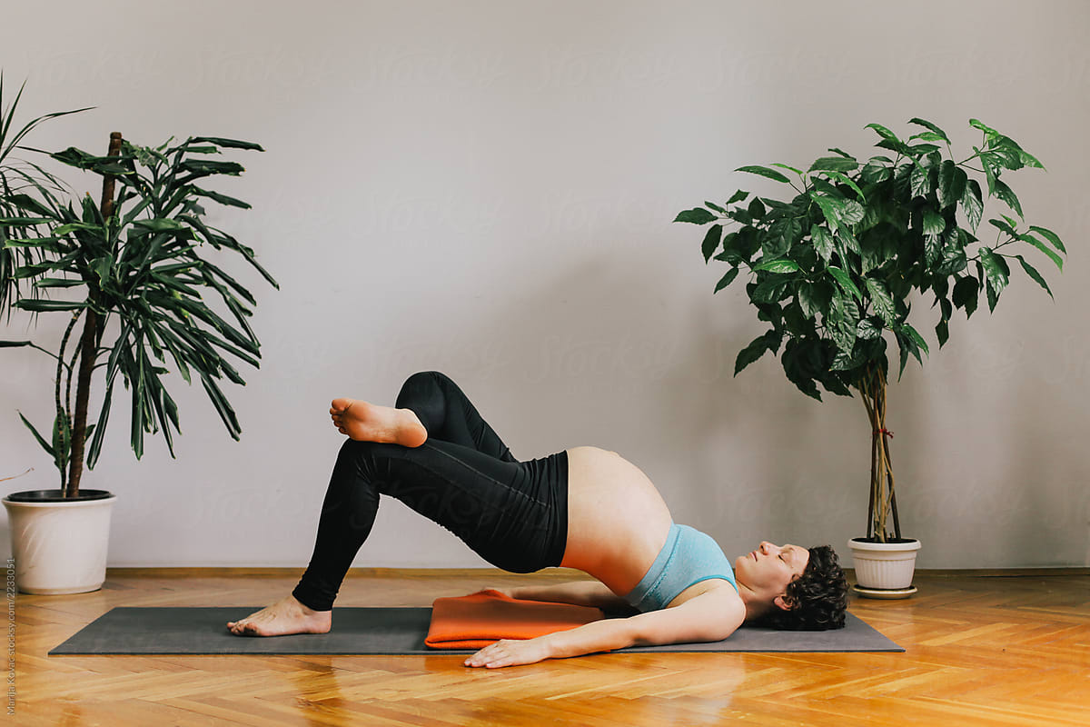 A pregnant woman practising yoga