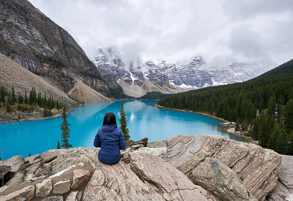 Woman admiring view of mountain lake