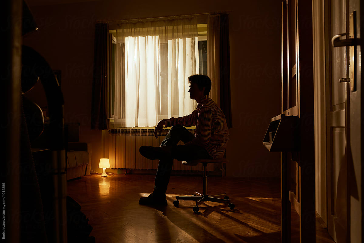 Silhouette Of Man Against Window by Stocksy Contributor