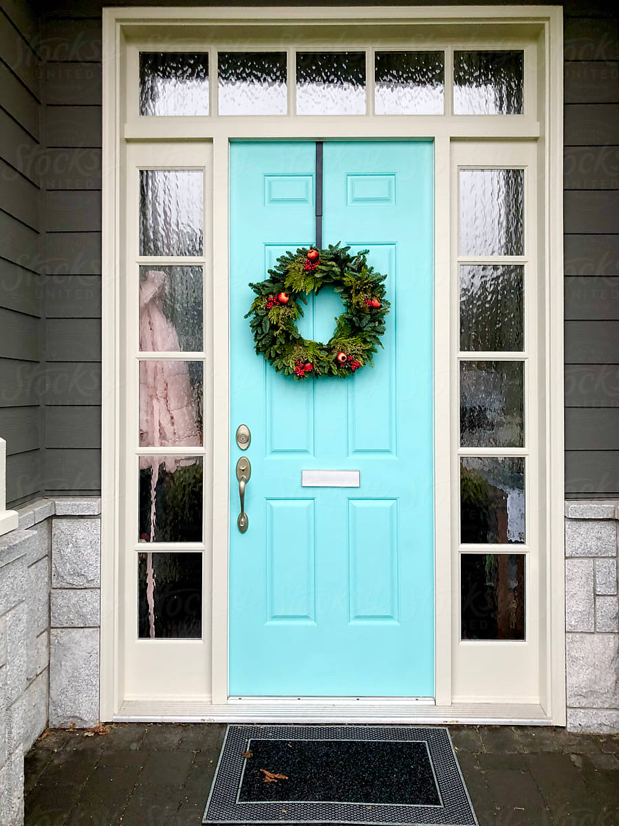 UGC Christmas wreath on light blue bright green door