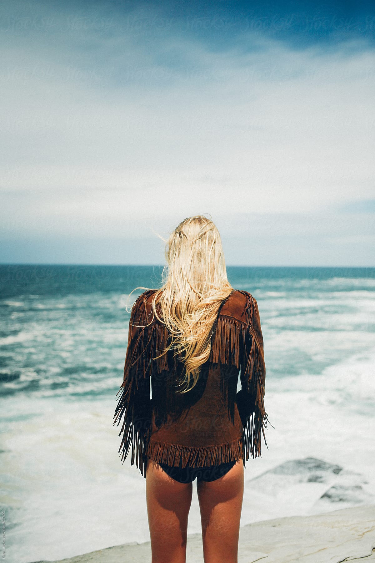 Woman facing ocean