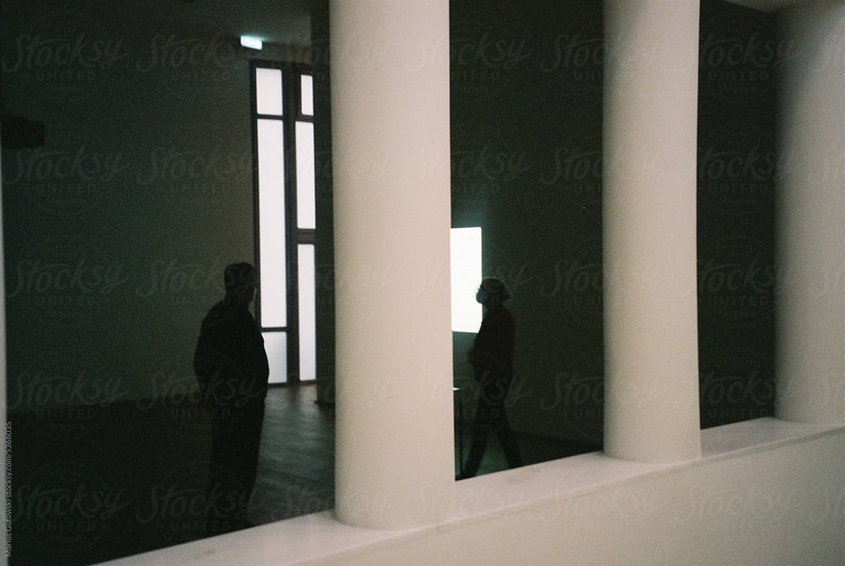 Two people standing inside an art gallery.