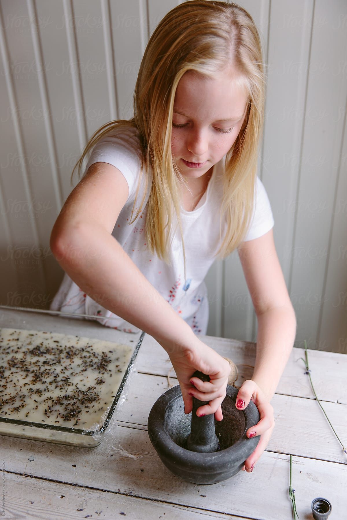 A female child making lavender soap