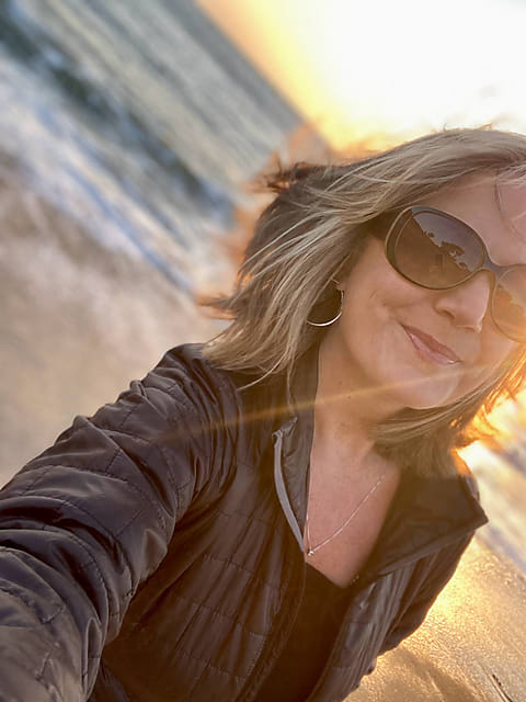 Teenage Girl On The Beach In A Hoodie And Heart Shaped Sunglasses by Stocksy  Contributor Carolyn Lagattuta - Stocksy